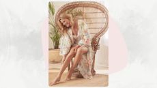 A woman sitting on a basket chair wearing a floral kaftan stretching her legs out in front of her and touching them