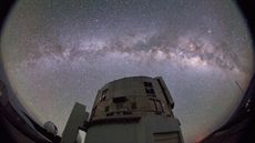 A photo of the Subaru Telescope against the night sky with the Milky Way clearly visible