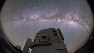 A photo of the Subaru Telescope against the night sky with the Milky Way clearly visible