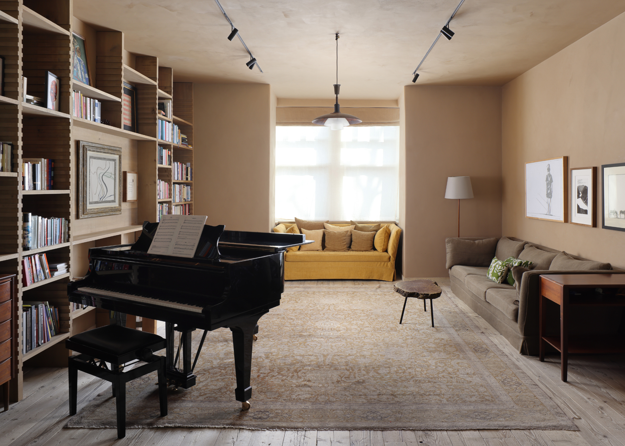 cozy living room with plaster finish walls and a grand piano