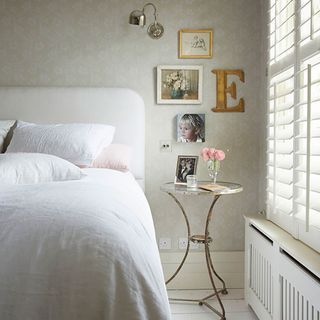 main bedroom with white wall and bed