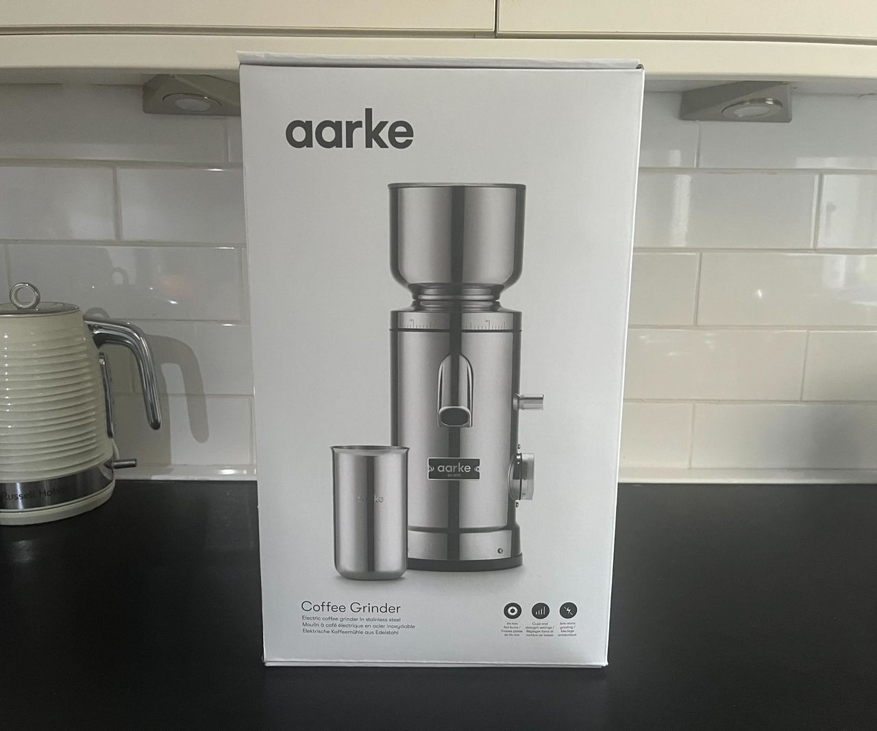 The white Aarke Coffee Grinder box with an image of the stainless steel coffee grinder on the front