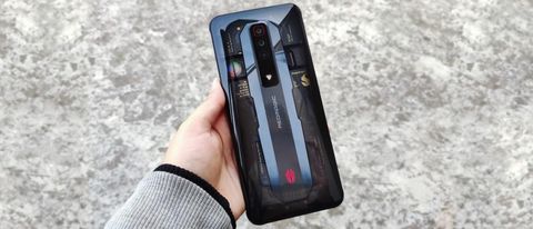 RedMagic 7 smartphone held in hand, showing off transparent back