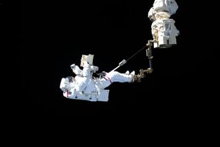 European Space Agency astronaut Luca Parmitano "stands" on the end of the International Space Station's Canadarm2 robotic arm during the first of four spacewalks to repair the Alpha Magnetic Spectrometer experiment together with NASA astronaut Drew Morgan, on Nov. 15, 2019.