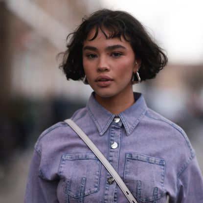 Woman with brunette French bob, purple denim shirt and dusky sunkissed blusher