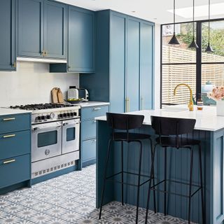 A modern kitchen with teal blue cupboards