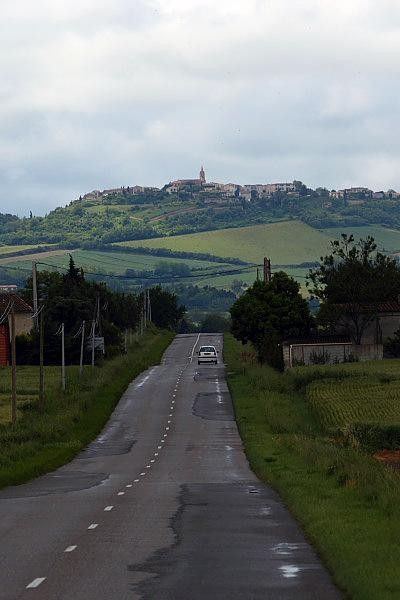 The village of Fanjeaux looms above the road