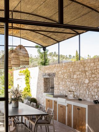 An outdoor kitchen with a roof made in bamboo