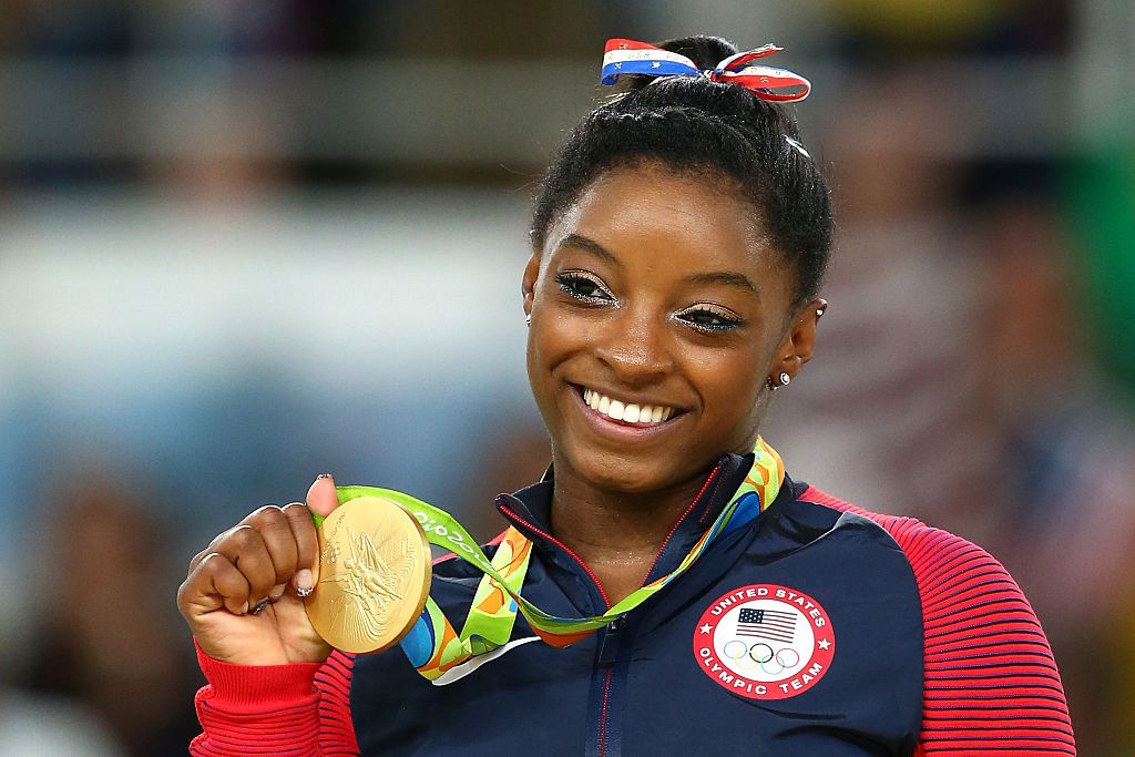 Simone Biles will carry the American flag at Sunday's Closing Ceremony ...