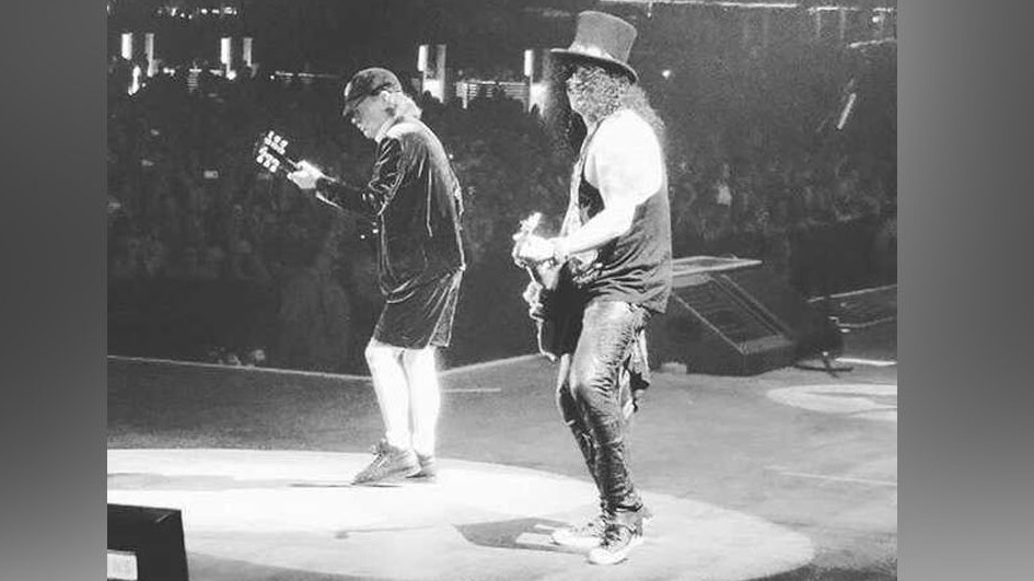 angus young of ac/dc on stage with guns n&#039; roses