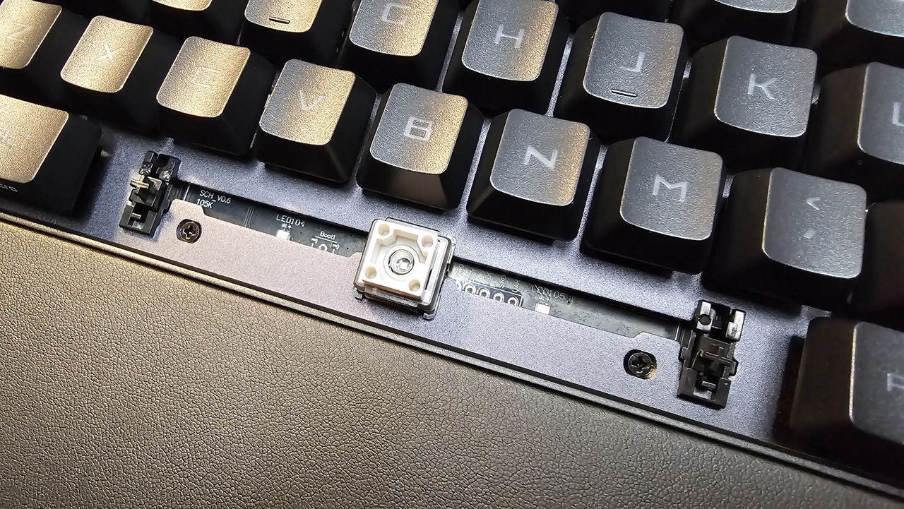 The Asus ROG Strix II RX gaming keyboard photographed on a wooden desk.