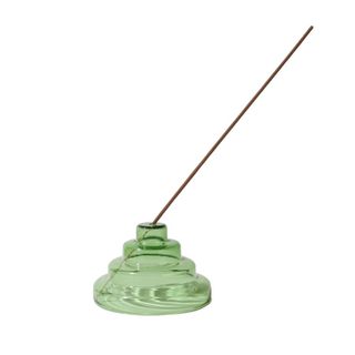 A green Incense holder made from glass