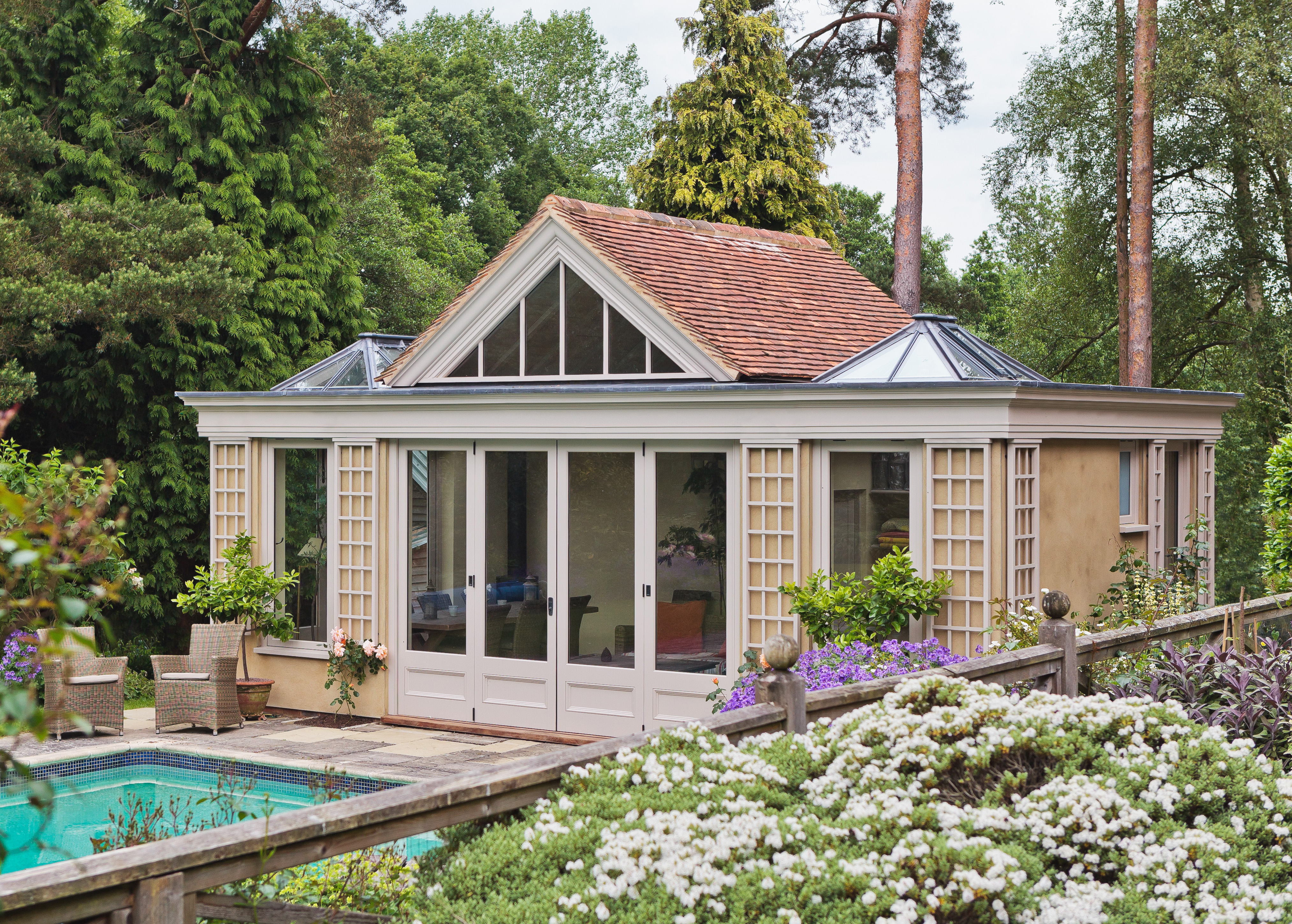 traditional outdoor garden room beside swimming pool