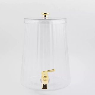 Clear beverage dispenser with gold faucet