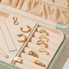 Jewelery case with delicate gold rings and necklaces