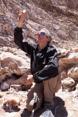 a women with short-cropped silver hair in a rocky desert canyon