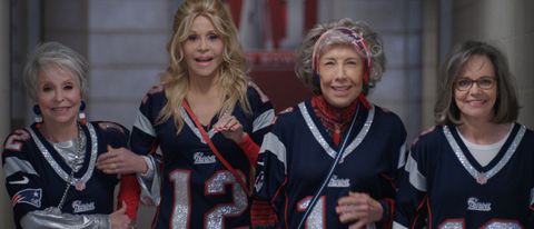 Rita Moreno, Jane Fonda, Lily Tomlin, and Sally Field walking together, while wearing Patriots jerseys, in 80 For Brady.