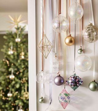 baubles hanging on wall from ribbons