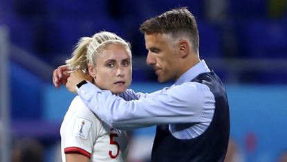 England head coach Phil Neville consoles Steph Houghton after the defeat against the United States