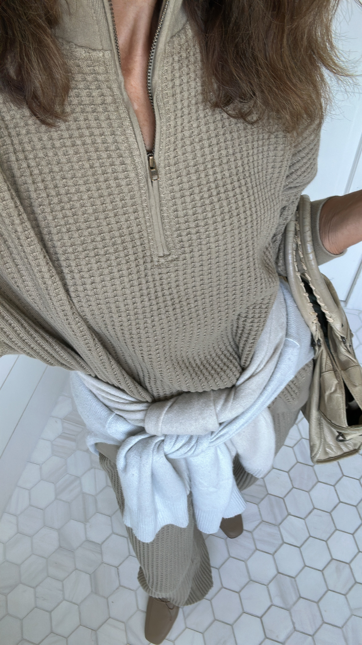 Larissa Mills wearing a sweater tied around her waist