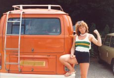 Female Rower posing in front of her camper van