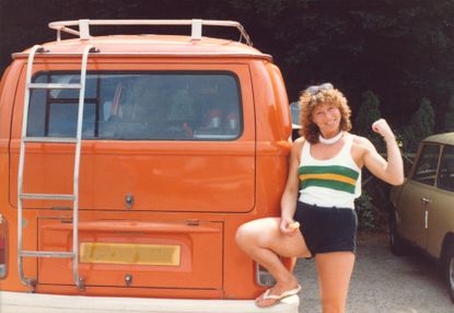 Female Rower posing in front of her camper van