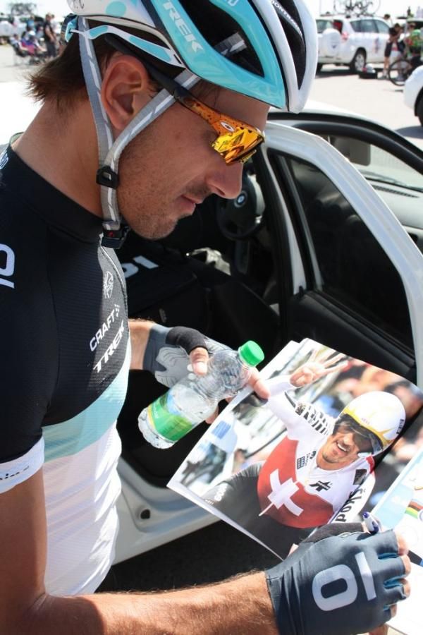Fabian Cancellara autographs a book