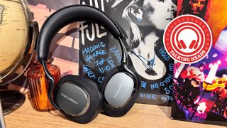 Bowers & wilkins Px7 S3 heapdhones on a desk with vinyl behind them