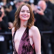 Emma Stone wears a plunge dress by Louis Vuitton on the Cannes 2024 red carpet