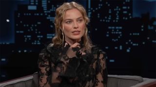 Margot Robbie talking about it getting hot growing up in a black lace dress while sitting in a chair talking to Jimmy Kimmel. 