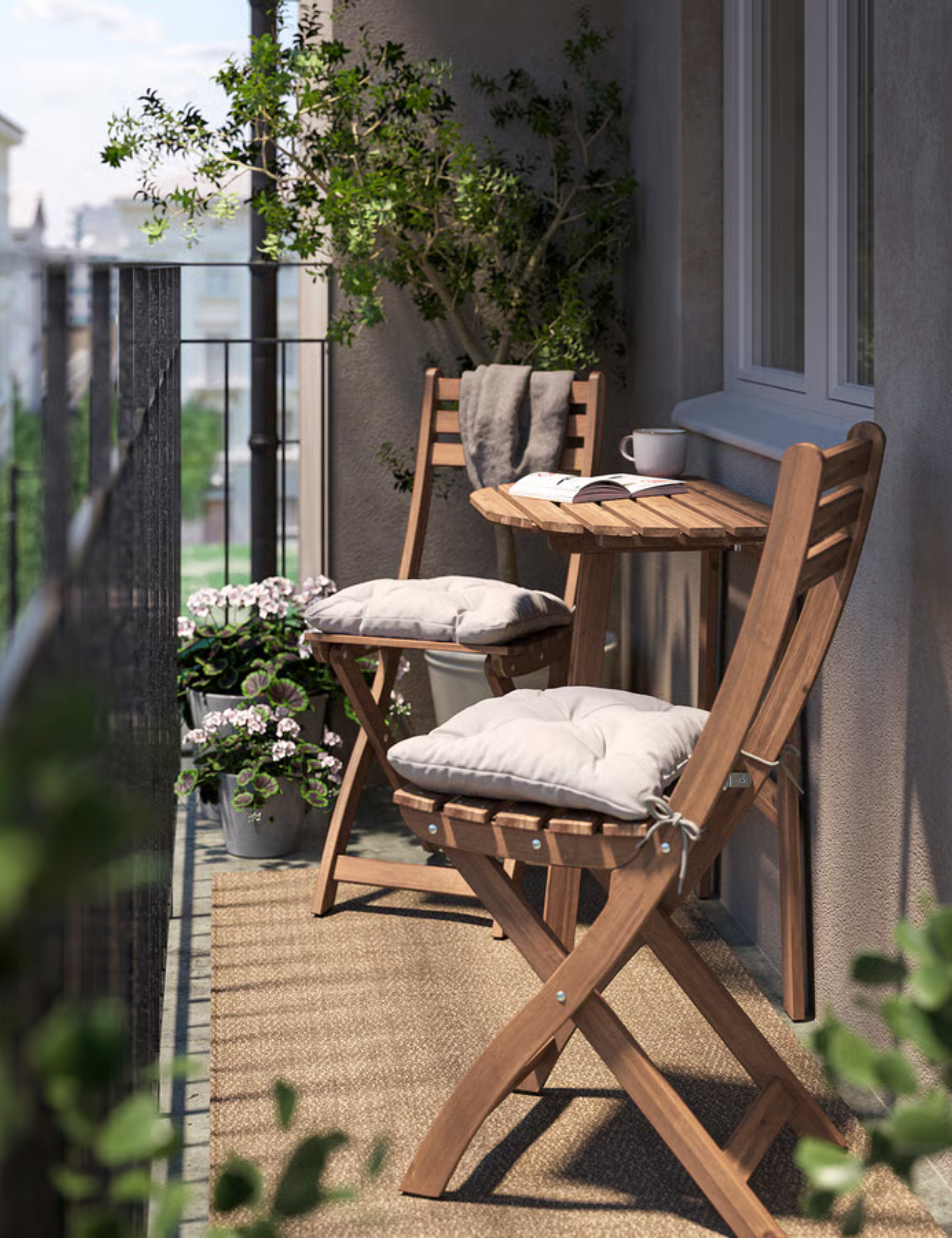 IKEA wooden outdoor wall table and chairs styled with cream tufted seat cushions atop of a small balcony