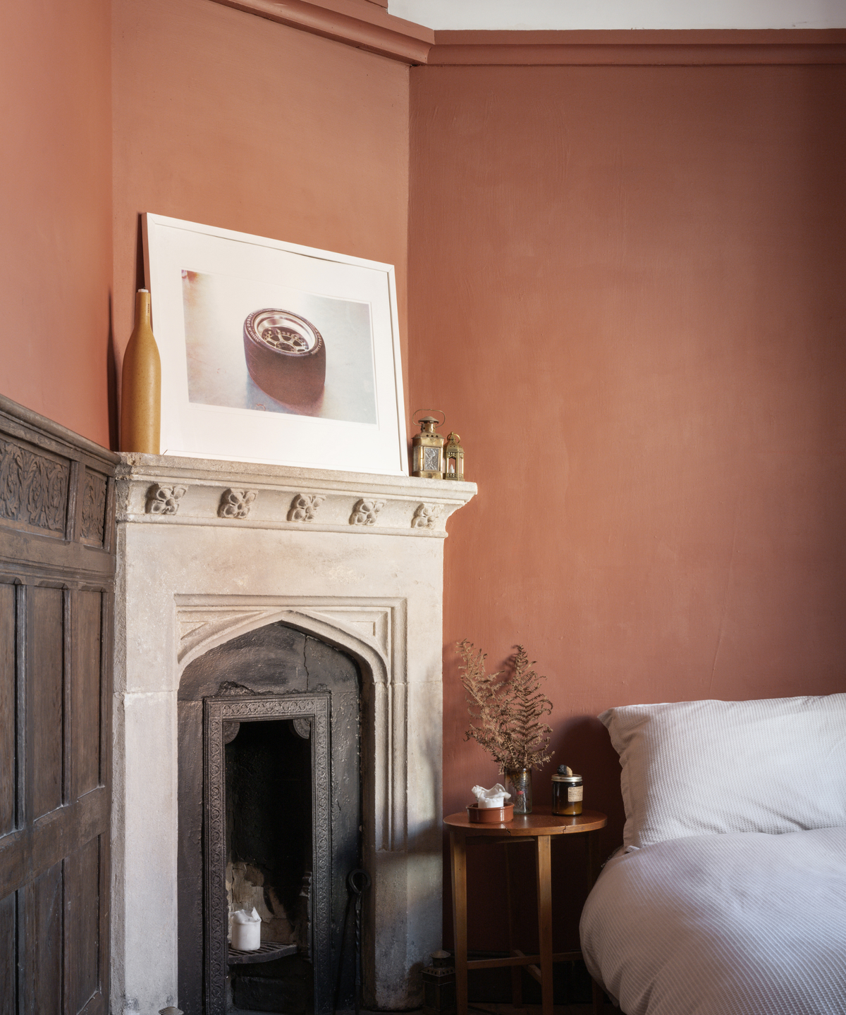 Fireplace in a bedroom with burnt orange walls
