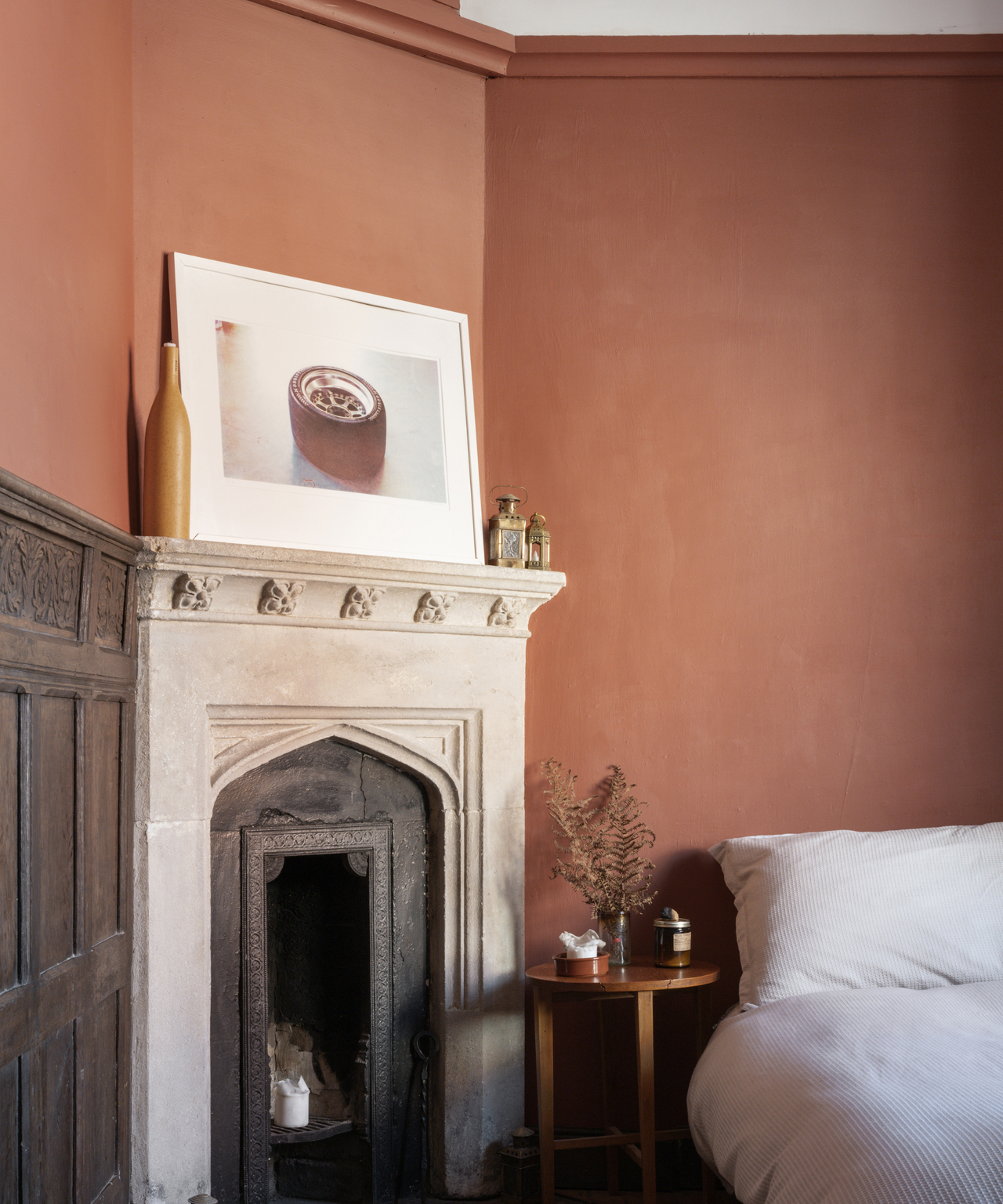 Fireplace in a bedroom with burnt orange walls