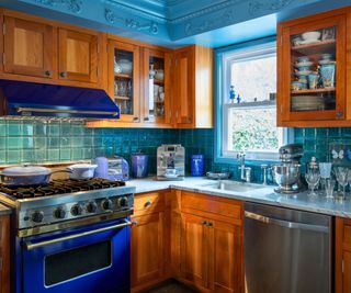 kitchen with blue walls and wooden cabinets