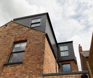 slate clad dormer loft extensions on red brick home