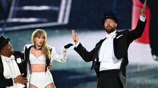 Taylor Swift is joined on stage by Travis Kelce (R), during "Taylor Swift | The Eras Tour" at Wembley Stadium on June 23, 2024 in London, England.