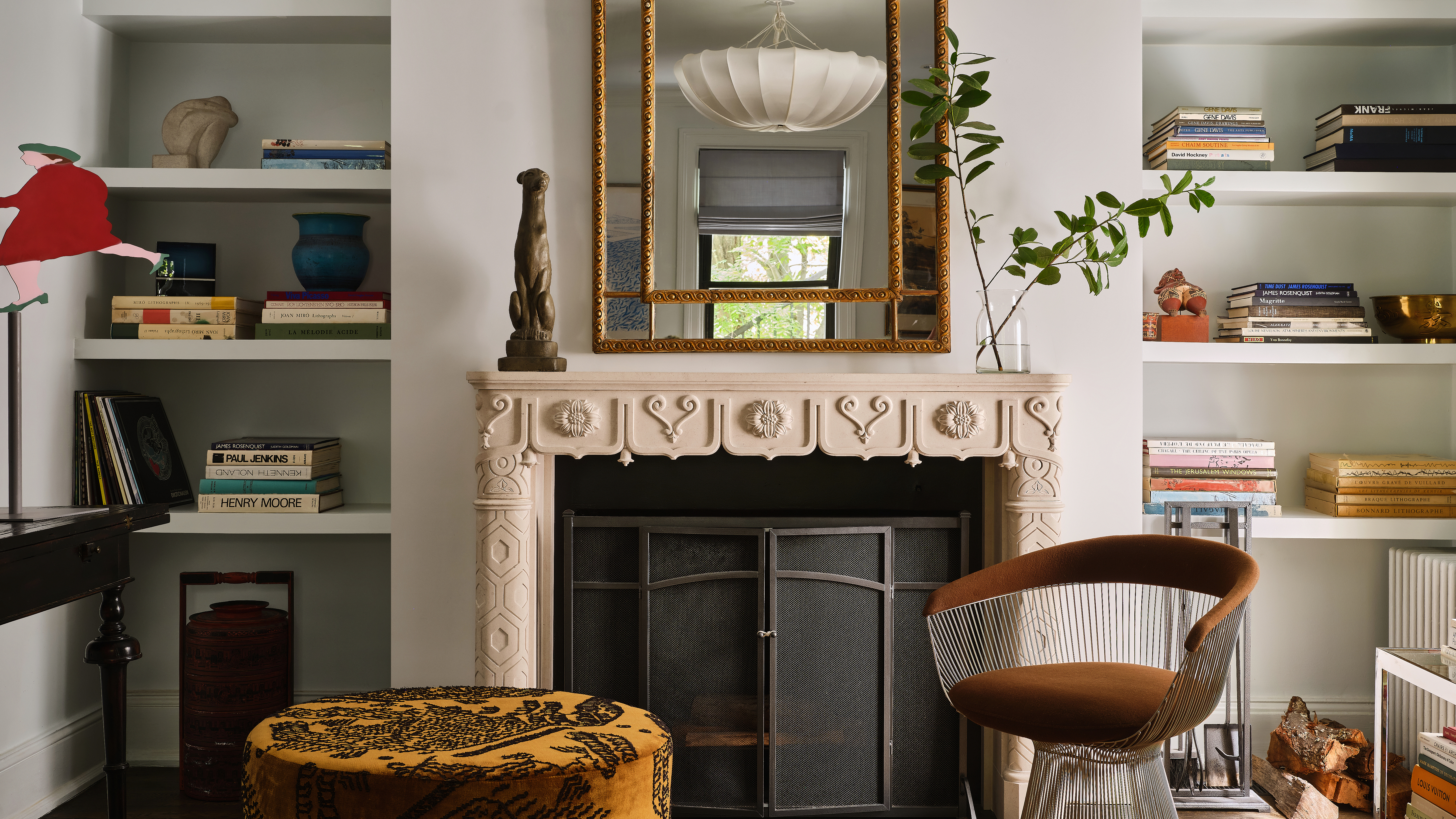 living room with modern chair and ornate fireplace
