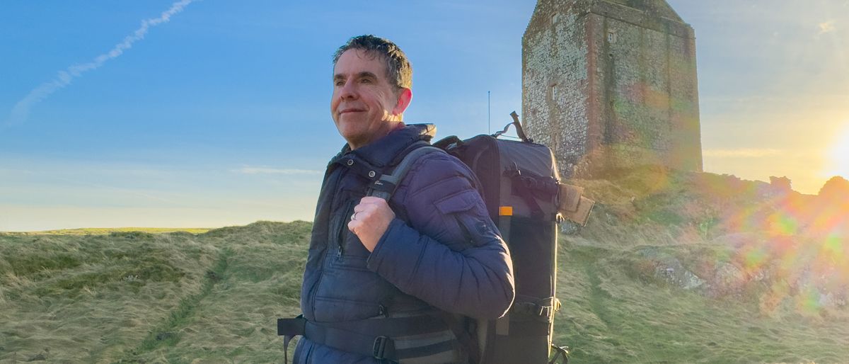 Lowepro Pro Trekker BP 650 AW II backpack on a mans&#039;s back outside in the scottish highlands