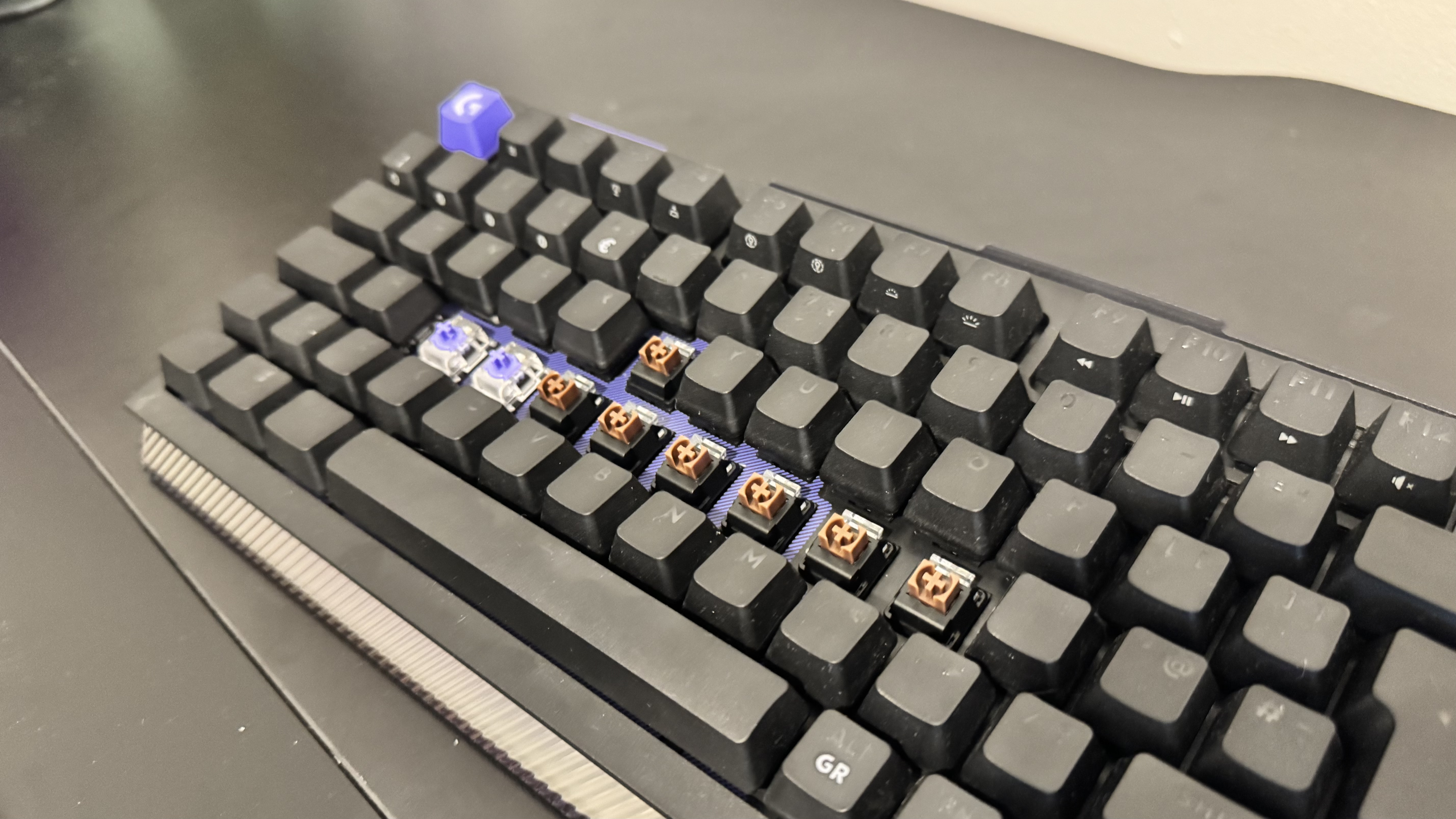 The Logitech G512 X gaming keyboard from the side, showing off the switch beds