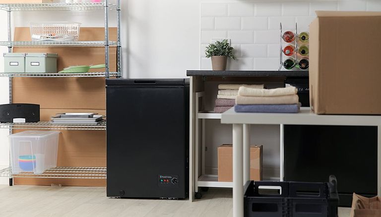 the Russell Hobbs RHCF99B Chest Freezer, one of the best chest freezer options, in a storage/utility room 