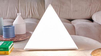 One of the best SAD lamps on the marker, the Northern Light Technologies Luxor Min sat on a beige tablei in a lounge