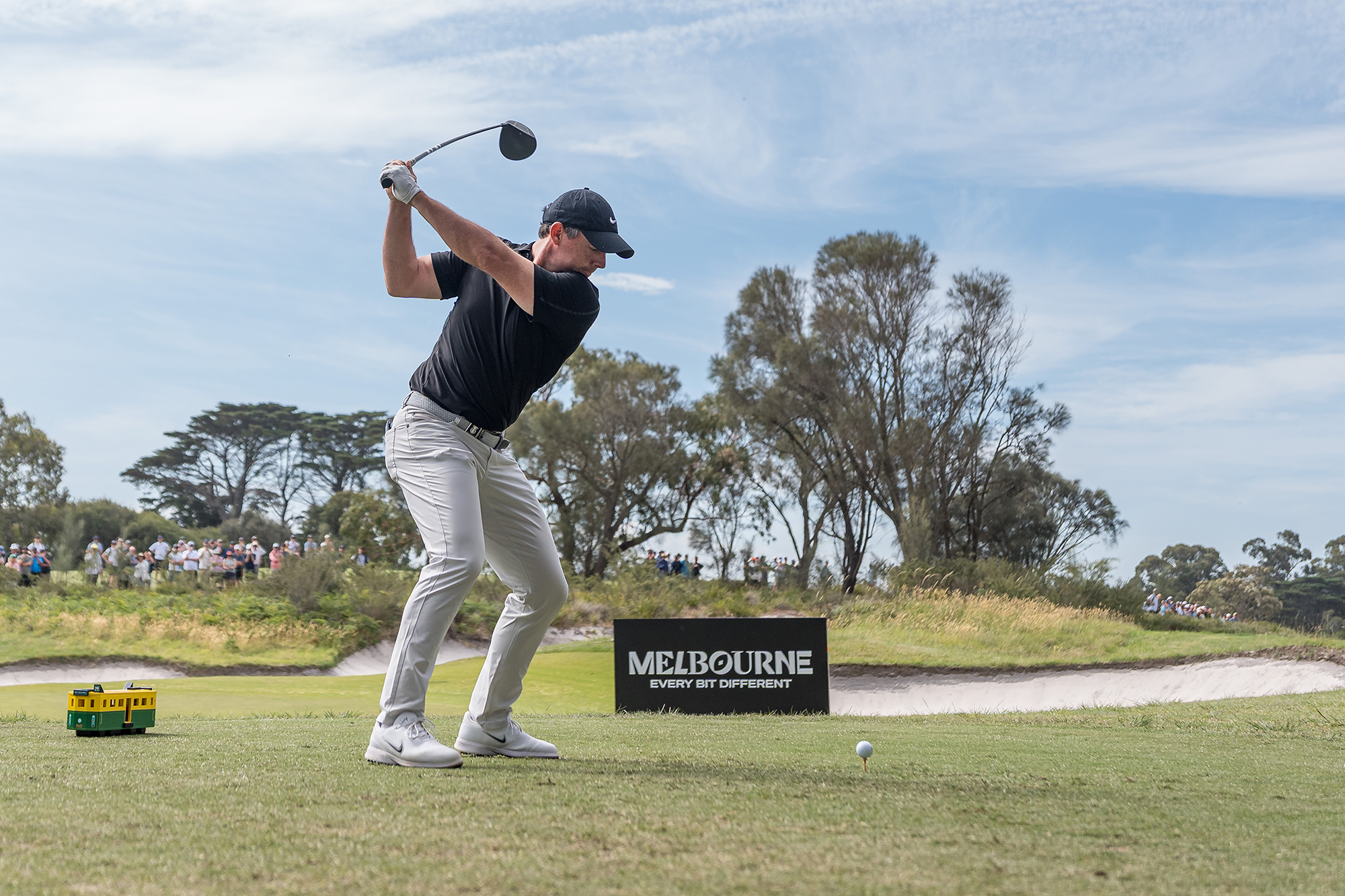 Rory McIlroy at the top of his backswing with driver, about to hit a tee shot at Royal Melbourne