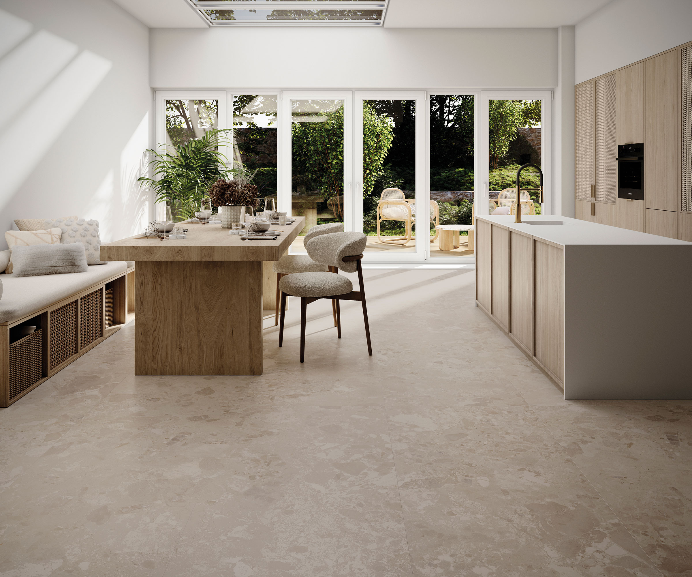 modern open plan kitchen diner with stone flooring and banquette seating