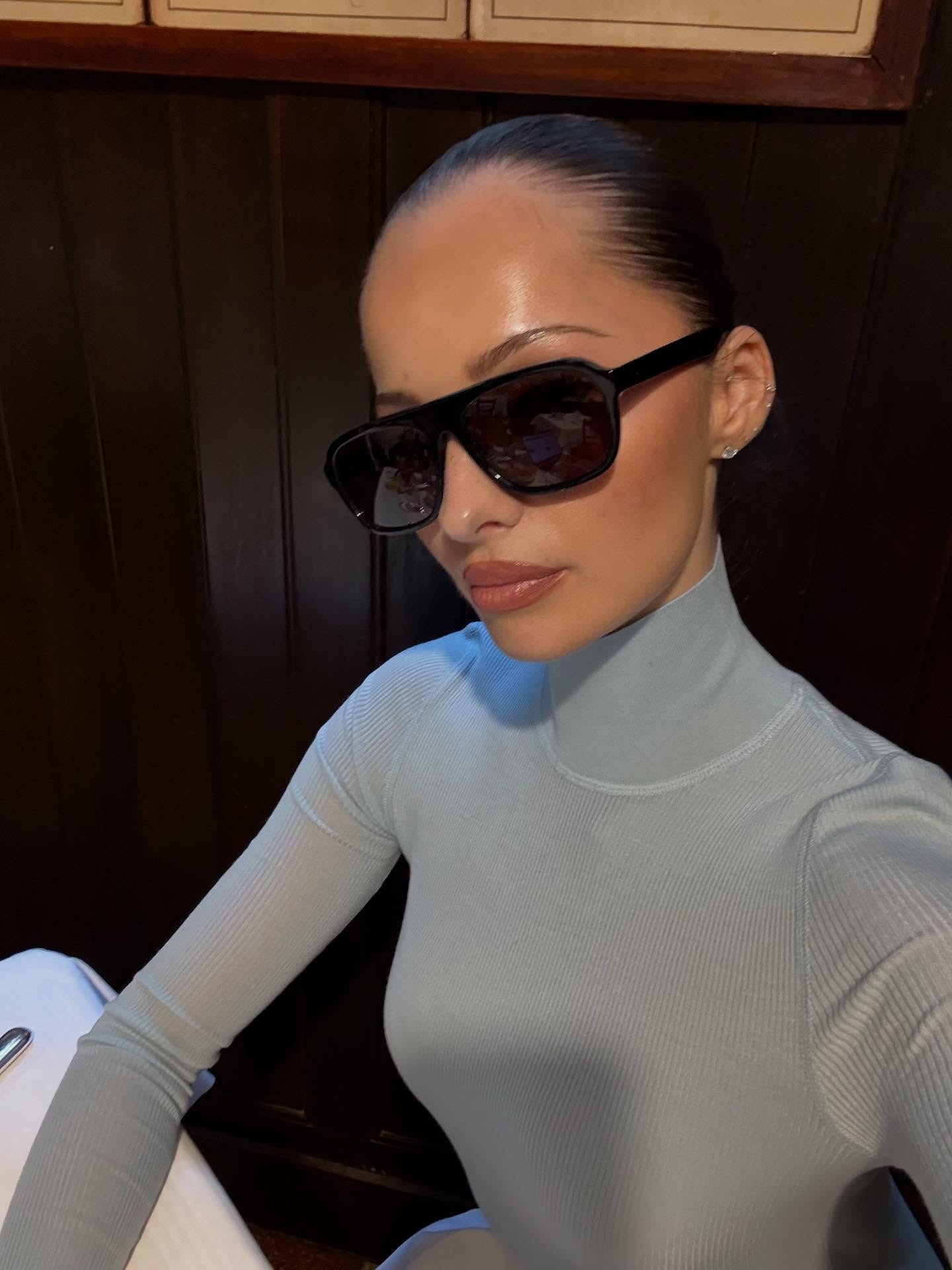 Woman in pale blue turtleneck