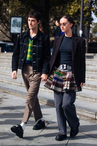 Woman wearing a Chopova Lowena skirt over jeans.