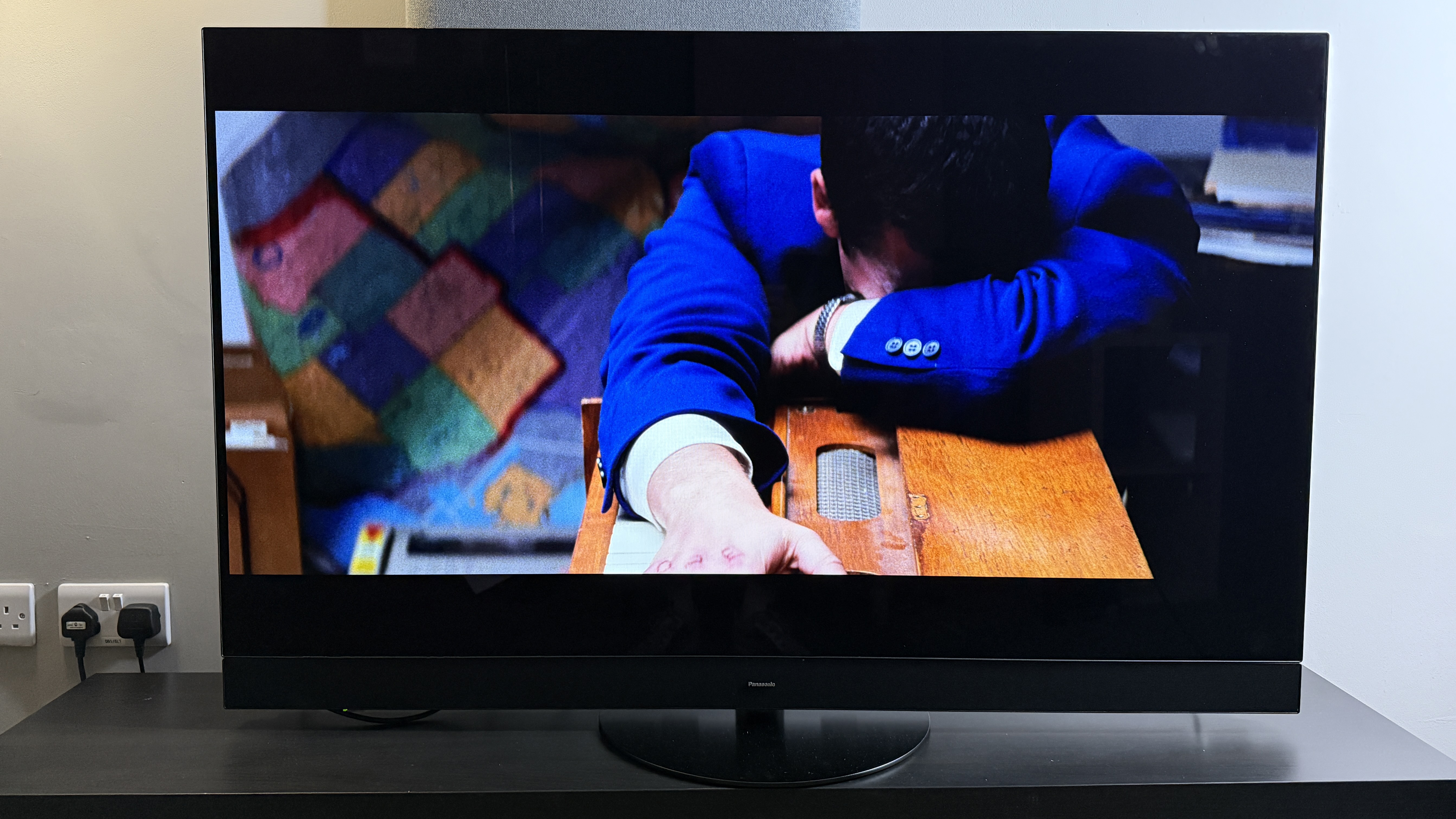 A TV showing the movie Punch-Drunk Love. On-screen, Adam Sandler is collapsed on a wooden piano