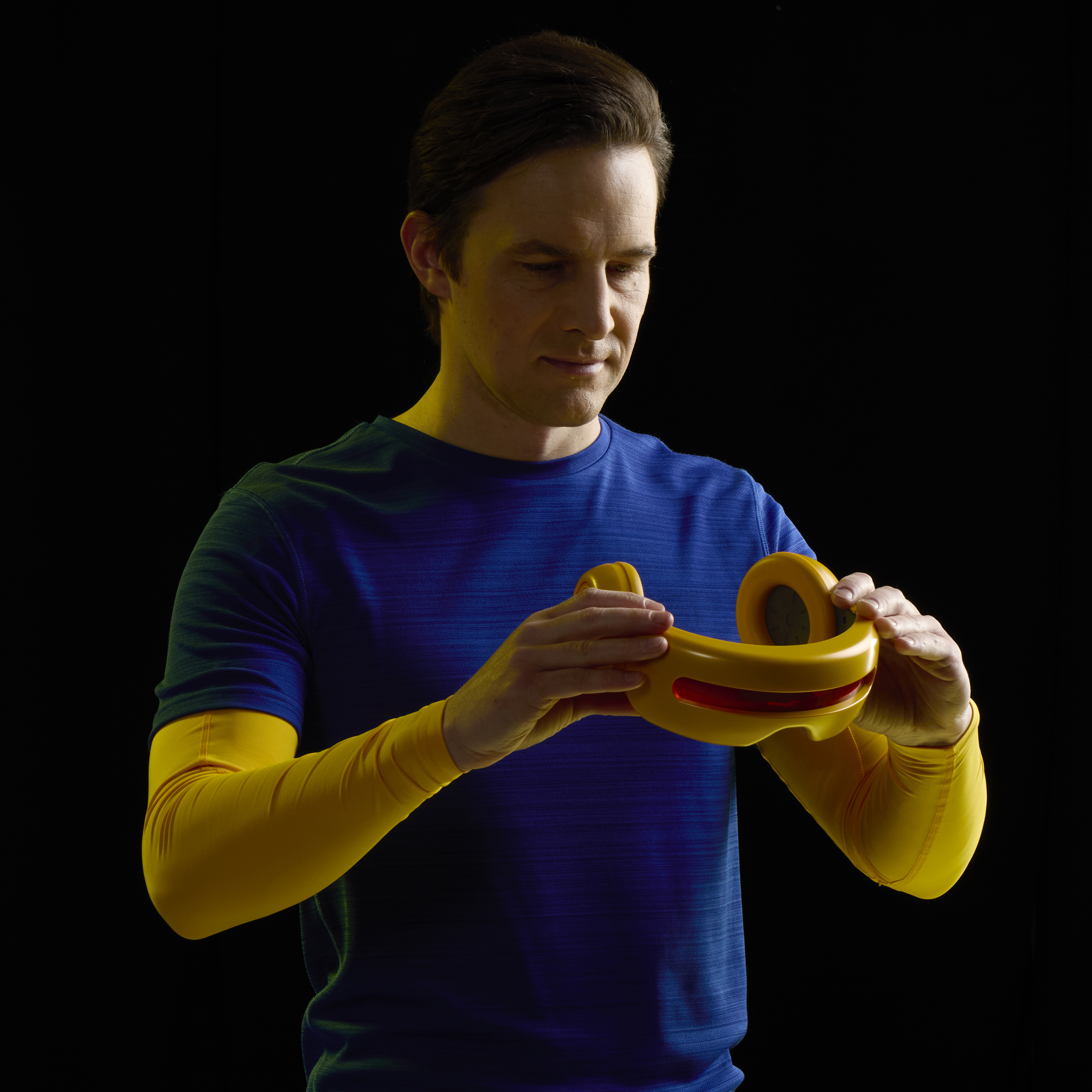 A man holds the X-Men Cyclops Visor against a dark background