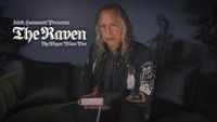 Kirk Hammett of Metallica holding a book