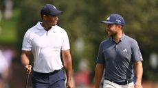 Tiger Woods of the United States and Xander Schauffele of the United States laugh as they walk up the fifth fairway during the first round of the 2023 Masters Tournament at Augusta National Golf Club on April 06, 2023 in Augusta, Georgia.