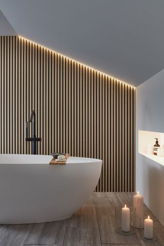 white freestanding bath with wooden wall panelling behind